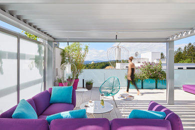 This is an example of a large contemporary roof terrace in Other with an outdoor kitchen and a pergola.