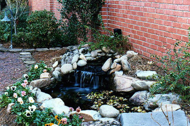 Design ideas for a backyard stone water fountain landscape in Other.