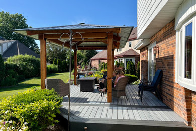 Deck - large modern backyard ground level deck idea in Denver