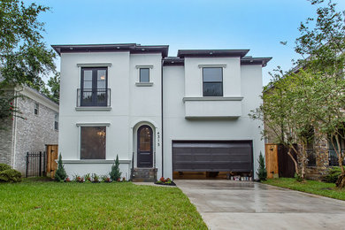 This is an example of a large transitional two-storey stucco white exterior in Houston with a gable roof.