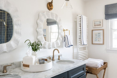 Example of a kids' blue tile and ceramic tile marble floor, white floor and double-sink bathroom design in Providence with blue cabinets, a one-piece toilet, white walls, an undermount sink, marble countertops, a hinged shower door, white countertops, a niche and a built-in vanity