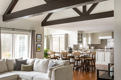 Example of a large transitional u-shaped dark wood floor, brown floor and exposed beam eat-in kitchen design in Boston with an undermount sink, beaded inset cabinets, white cabinets, quartzite countertops, beige backsplash, stone slab backsplash, stainless steel appliances, an island and beige countertops