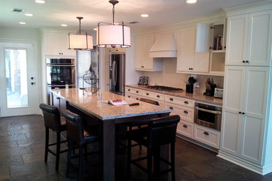 Enclosed kitchen - mid-sized transitional single-wall ceramic tile and brown floor enclosed kitchen idea in New Orleans with shaker cabinets, beige cabinets, granite countertops, stainless steel appliances, an island and multicolored countertops