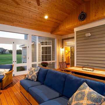 Design Builders screened porch with stone fireplace & Ipe deck in Sykesville MD
