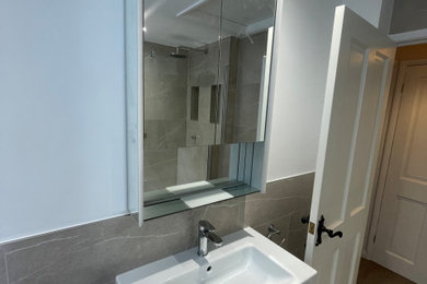 Large contemporary family bathroom in Surrey with a corner bath, a walk-in shower, a wall-mounted sink, an open shower and a single sink.