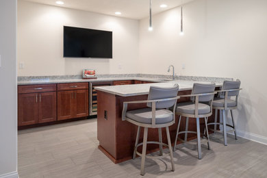 Wet bar - large contemporary porcelain tile and gray floor wet bar idea in Indianapolis with an undermount sink, shaker cabinets, medium tone wood cabinets, granite countertops and gray countertops