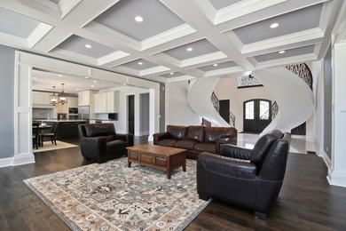 Example of a minimalist formal and open concept dark wood floor living room design in Chicago with gray walls, a standard fireplace, a stone fireplace and a media wall