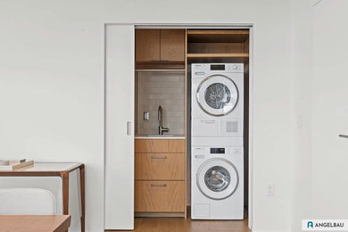 Laundry closet - mid-sized contemporary laundry closet idea in Denver with an undermount sink, flat-panel cabinets, quartz countertops, beige backsplash, ceramic backsplash and white walls