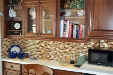 Kitchen - mid-sized traditional l-shaped kitchen idea in Other with medium tone wood cabinets, multicolored backsplash and stainless steel appliances