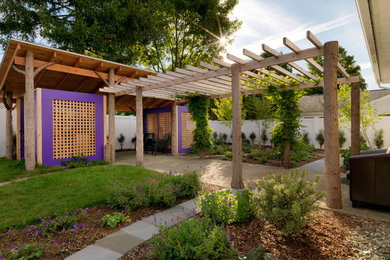 Photo of an eclectic full sun backyard stone landscaping in Burlington.