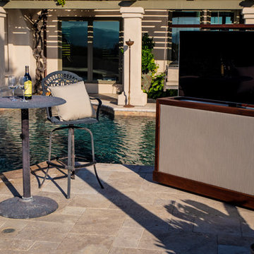 Sunbrella and wood backyard TV lift cabinet swivels and moves to watch TV anywhe
