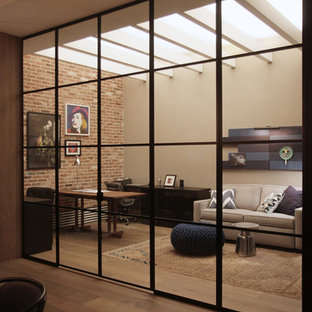 Design ideas for a large urban home studio in New York with beige walls, medium hardwood flooring and a freestanding desk.