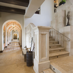 Inspiration for a mediterranean metal railing staircase in Austin with travertine treads and travertine risers.