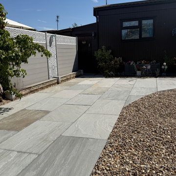 Porcelain Path Curving Through Shingle to a Lodge
