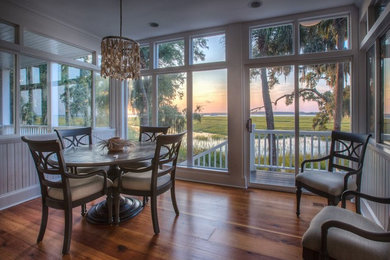 Inspiration for a mid-sized coastal medium tone wood floor and brown floor kitchen/dining room combo remodel in Atlanta with white walls and no fireplace