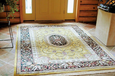 Inspiration for a mid-sized slate floor and brown floor entryway remodel in Other with a yellow front door