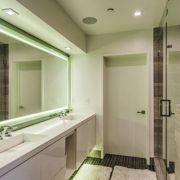 Frameless Glass Shower Beside Backlit Vanity Mirror