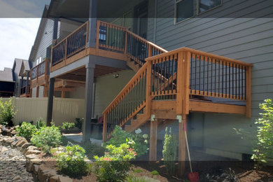 Mid-sized minimalist backyard second story mixed material railing deck photo in Portland