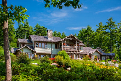 Mid-sized craftsman green two-story wood exterior home idea in Portland Maine with a shingle roof