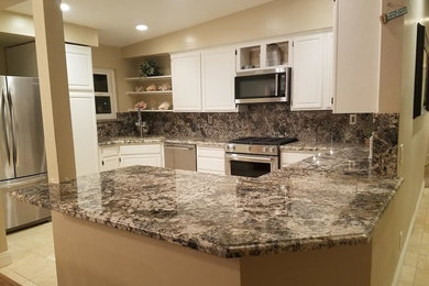 Inspiration for a mid-sized timeless u-shaped ceramic tile and beige floor kitchen remodel in Los Angeles with an undermount sink, raised-panel cabinets, white cabinets, granite countertops, multicolored backsplash, stone slab backsplash, stainless steel appliances, a peninsula and multicolored countertops