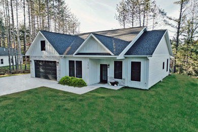 Mid-sized farmhouse white one-story wood and board and batten exterior home photo in Other with a shingle roof and a gray roof