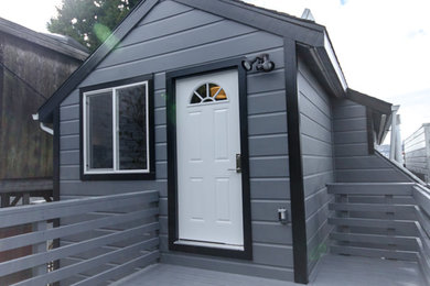Inspiration for a mid-sized gray wood gable roof remodel in San Francisco