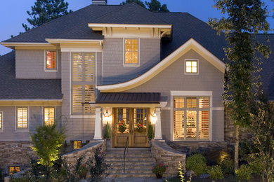 Inspiration for a traditional two-storey grey exterior in Other with wood siding and a mixed roof.