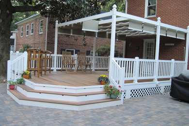 Example of a mid-sized transitional backyard deck design in Other with a pergola