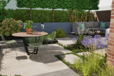 This is an example of a large backyard concrete paver formal garden in Other.