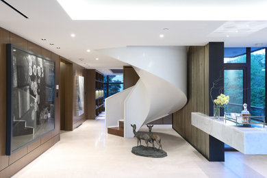 Large trendy wooden curved staircase photo in Vancouver with wooden risers