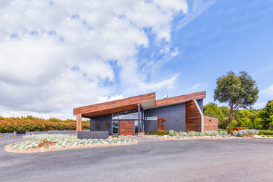 This is an example of a mid-sized contemporary home design in Hobart.