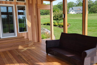 Mid-sized back porch photo in DC Metro with a roof extension
