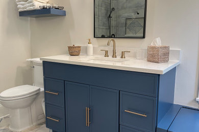 Example of a large transitional master blue tile and ceramic tile single-sink sliding shower door design in Charleston with flat-panel cabinets, blue cabinets, an undermount sink, quartzite countertops, white countertops and a built-in vanity