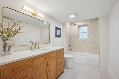 Inspiration for a mid-sized modern master beige tile and cement tile porcelain tile, gray floor and single-sink bathroom remodel in Columbus with shaker cabinets, light wood cabinets, a one-piece toilet, white walls, an undermount sink, quartz countertops, white countertops and a freestanding vanity