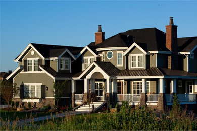 Huge traditional green two-story wood gable roof idea in New York