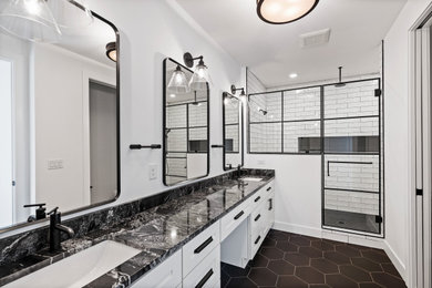 Bathroom - transitional white tile and ceramic tile cement tile floor, black floor and double-sink bathroom idea in Cincinnati with shaker cabinets, white cabinets, white walls, an undermount sink, granite countertops, a hinged shower door, black countertops and a niche