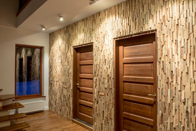 Hallway - small modern light wood floor hallway idea in Other with white walls