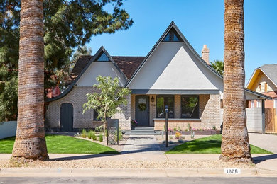 Mid-sized eclectic beige two-story brick house exterior photo in Phoenix