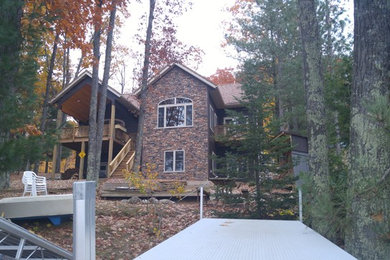Inspiration for a mid-sized rustic multicolored two-story mixed siding gable roof remodel in Amsterdam