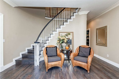 Inspiration for a large dark wood floor and brown floor foyer remodel in Boise with beige walls