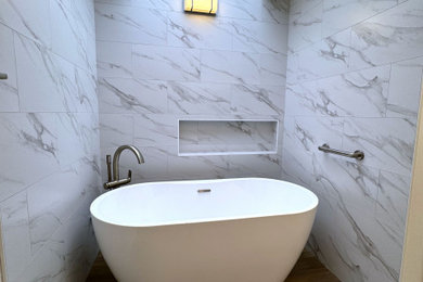 Bathroom - master white tile light wood floor, brown floor, double-sink and wood ceiling bathroom idea in Seattle with a one-piece toilet, white walls and a freestanding vanity