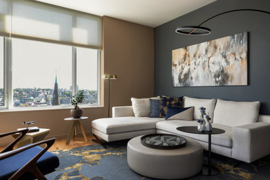Mid-sized trendy open concept vinyl floor and brown floor living room photo with beige walls and a wall-mounted tv