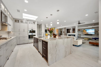 Example of a large trendy l-shaped porcelain tile and beige floor eat-in kitchen design in Phoenix with an undermount sink, flat-panel cabinets, gray cabinets, quartzite countertops, beige backsplash, stainless steel appliances, an island and beige countertops