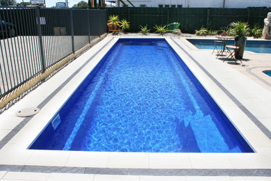 This is an example of a large modern backyard rectangular lap pool in Perth.
