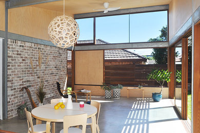 This is an example of a mid-sized contemporary open concept living room in Sydney with concrete floors and white floor.