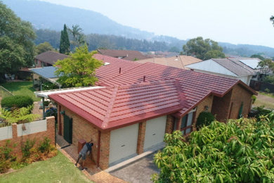 Inspiration for a large traditional one-storey brick house exterior in Central Coast with a hip roof and a tile roof.