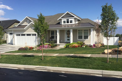 Mid-sized arts and crafts beige two-story wood exterior home photo in Salt Lake City with a hip roof