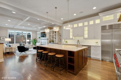 Open concept kitchen - large modern l-shaped dark wood floor and brown floor open concept kitchen idea in Chicago with an undermount sink, glass-front cabinets, white cabinets, quartzite countertops, white backsplash, stone tile backsplash, stainless steel appliances and an island