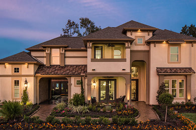 Contemporary two-storey stucco beige exterior in Houston with a hip roof.