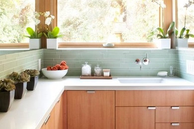 Inspiration for a modern master green tile and glass tile slate floor and gray floor tub/shower combo remodel in San Francisco with flat-panel cabinets, medium tone wood cabinets, an undermount tub, green walls, an undermount sink, quartz countertops, a hinged shower door and white countertops